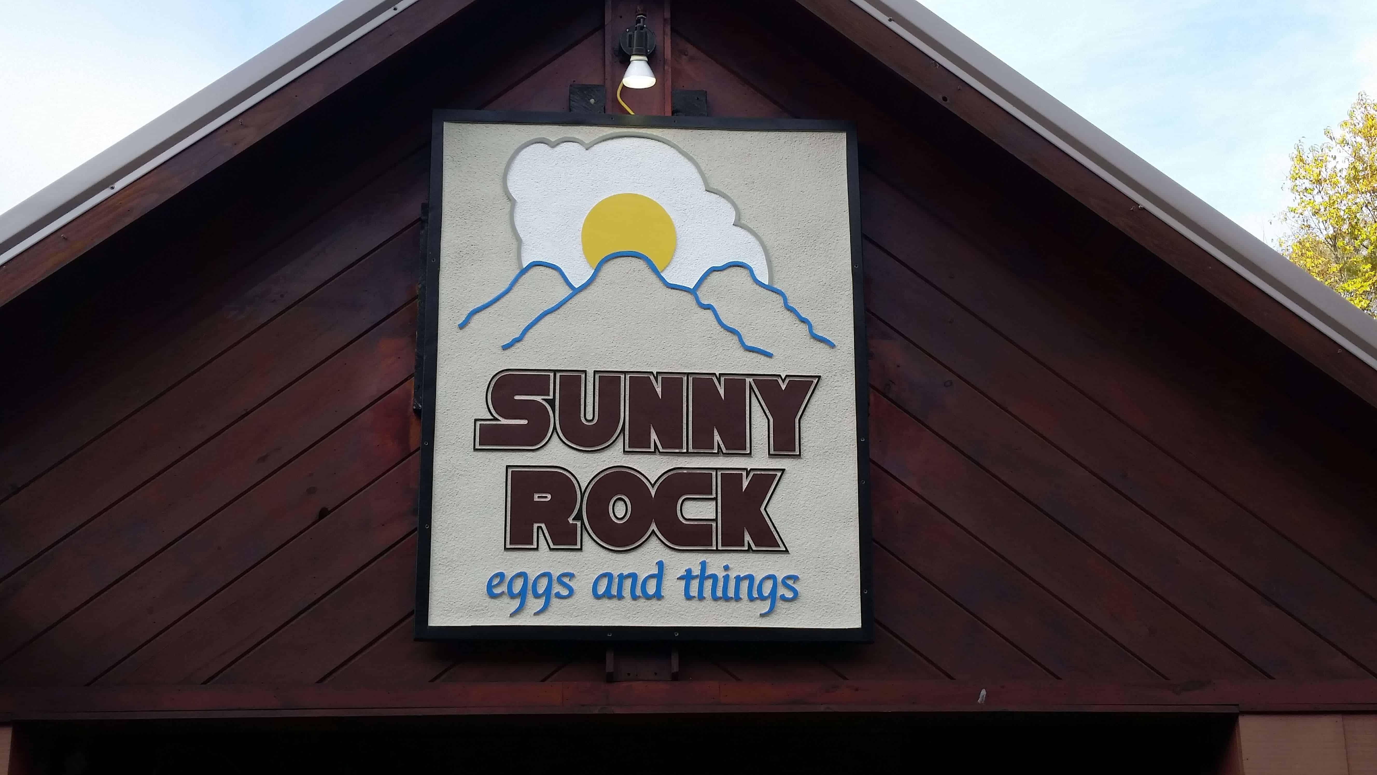 This image shows the front of the the building of Sunny Rock Eggs and Things and it is zoomed up to show what the sign looks like.