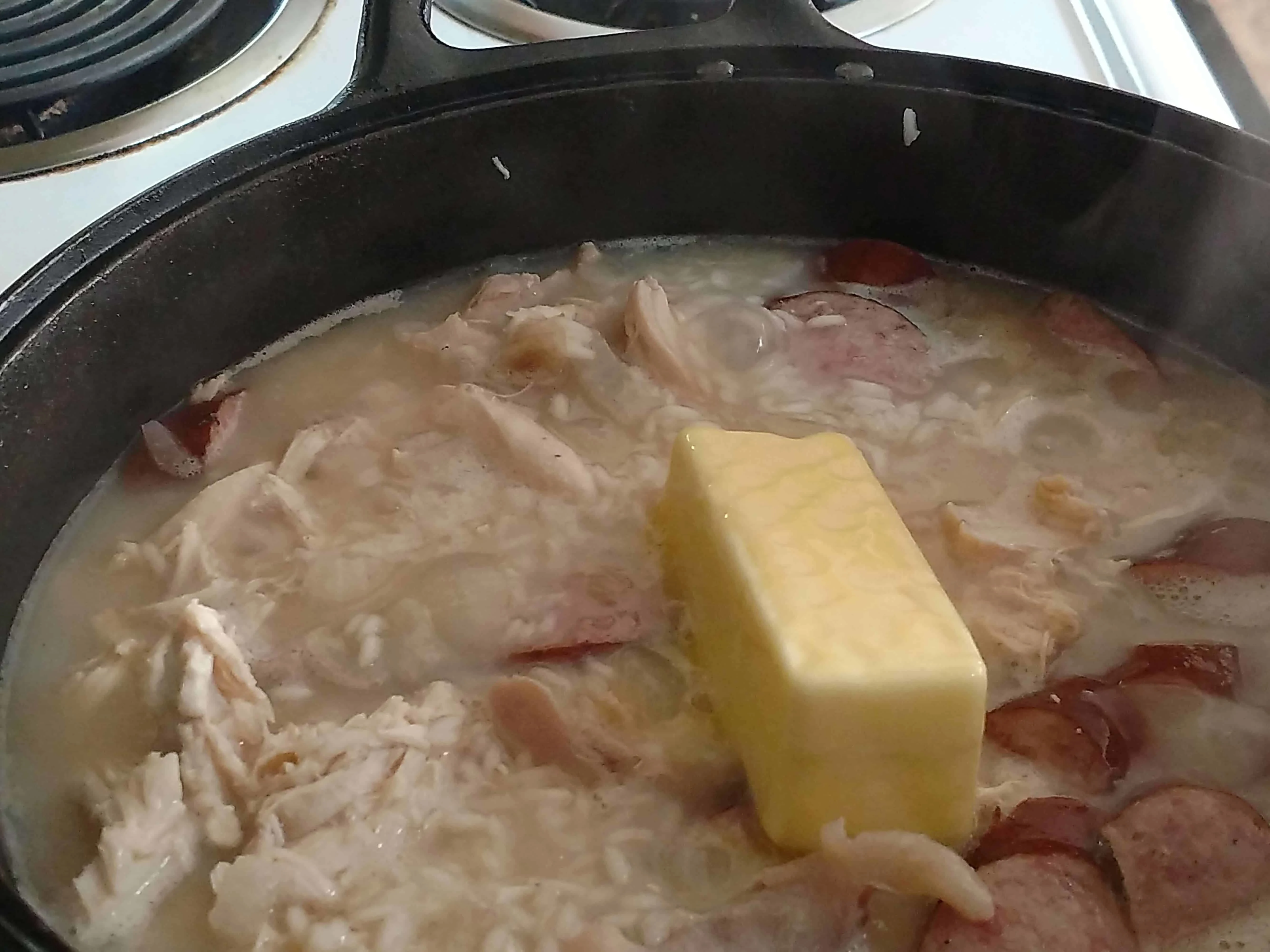 Adding butter to make Southern Chicken bog.