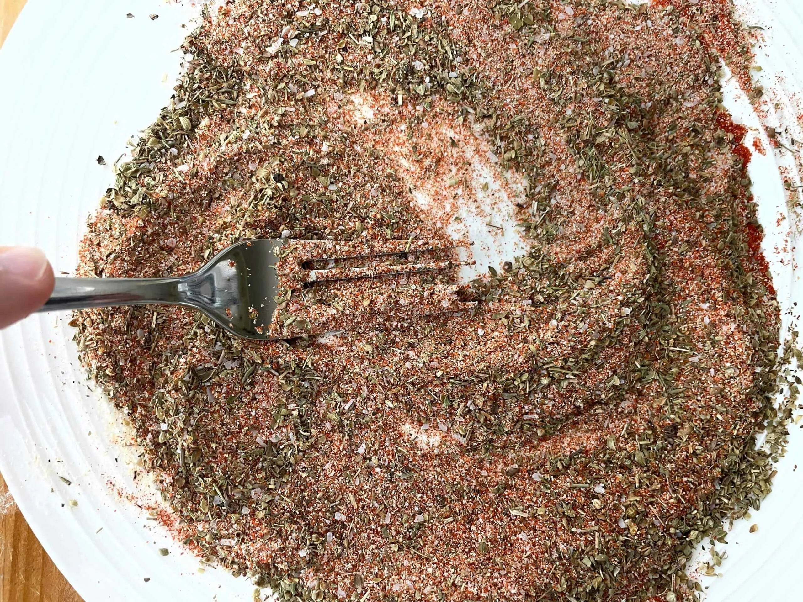 https://southernfoodjunkie.com/wp-content/uploads/2022/05/Mixing-the-chicken-seasoning-2-scaled.jpg.webp