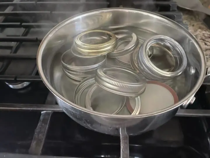 lids and rings sterlizing in a saucepan for canning purposes.