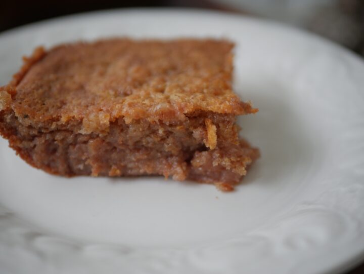 Close-up of the edge of a slice of persimmon pudding to show the texture of the inside of it.