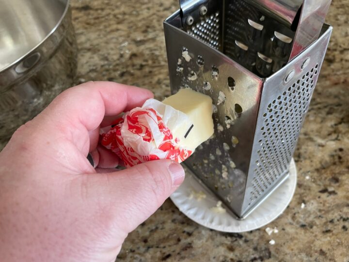 grating frozen butter on a box grater.