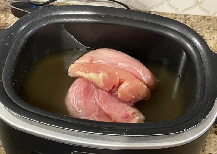 Skinless boneless chicken breast in the crock pot.
