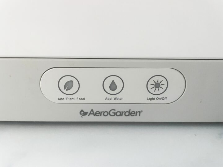 Closeup of the front panel of the AeroGarden showing the buttons and lights.