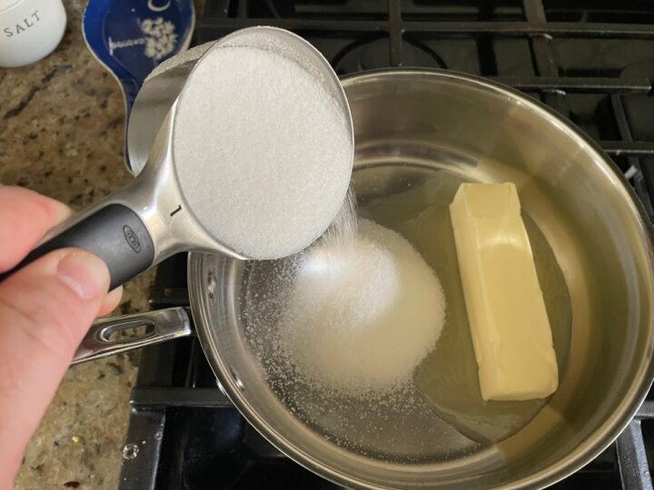 adding sugar to butter for yum yum cake topping.