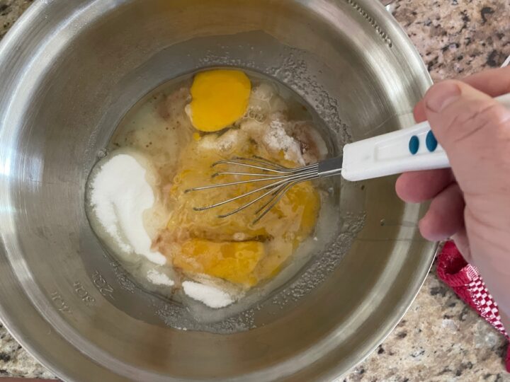 Creaming sugar, eggs, and vanilla together. 