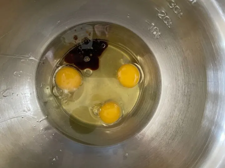 Adding vanilla to eggs.