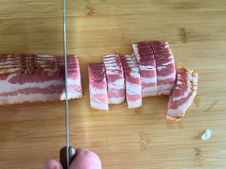 Cutting bacon into small pieces.