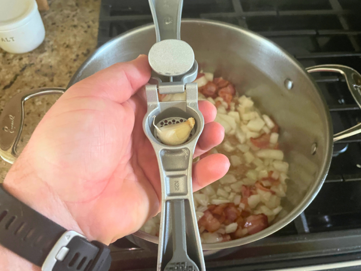 Showing how to use the garlic press.