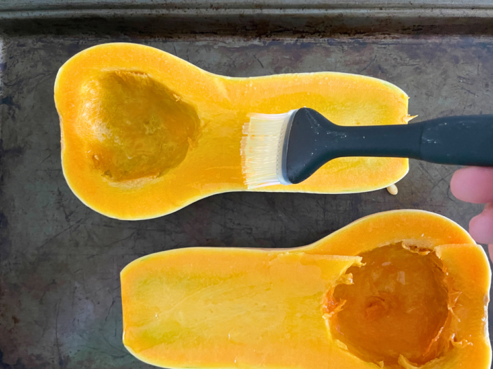 Brushing olive oil on the butternut squash.