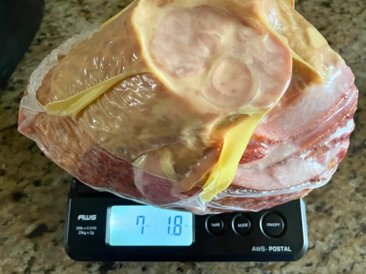 This image is showing that you need to know the weight of your smoked ham before reheating it. The weight tells us how long we will need to reheat it for.
