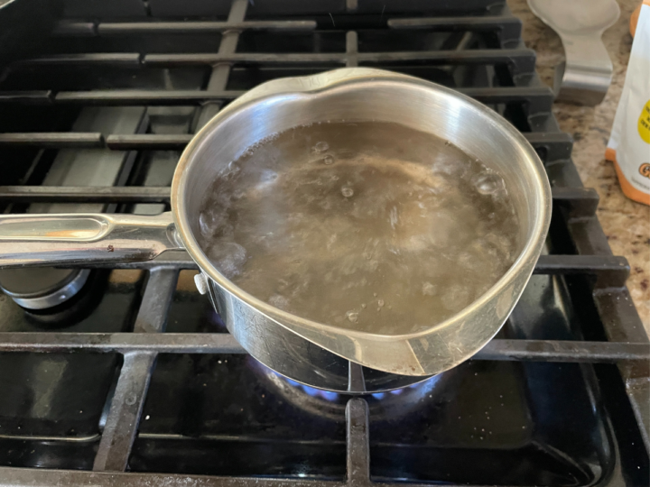 This photo is a pot of water boiling in order to make sweet tea.