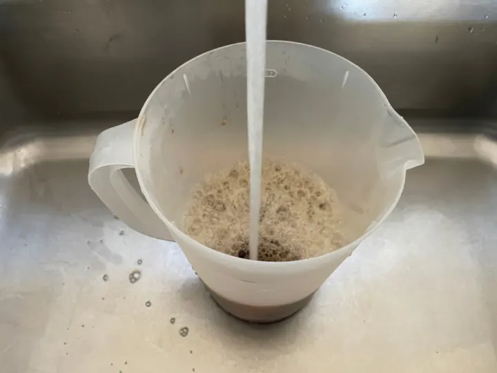 this photo is filling the pitcher the rest of the way up with water. 