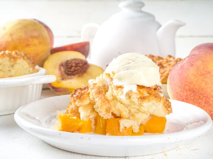 close up of peach cobbler with vanilla ice cream on top. 