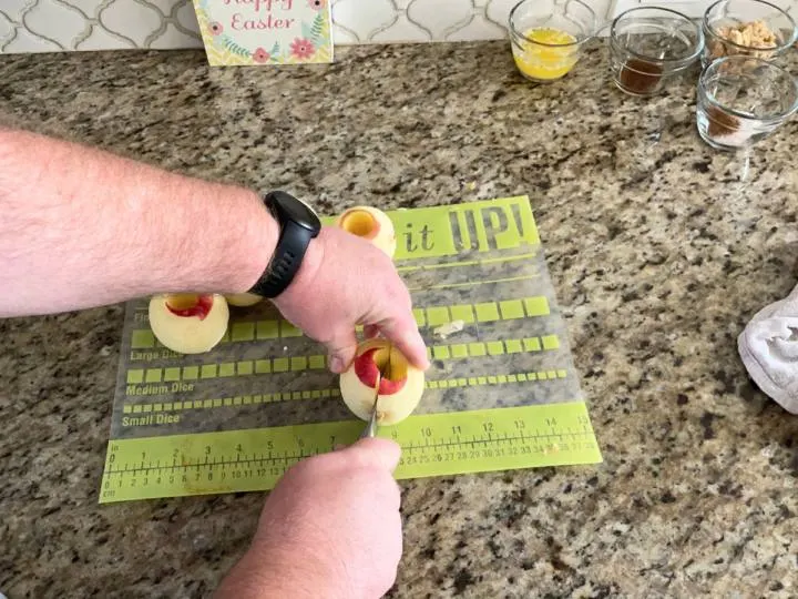 This image shows slicing apples that have just been peeled.