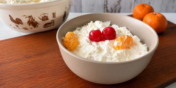 Easy fruit fluff recipe made with mandarin oranges, pineapple, Cool Whip, and cheesecake pudding.