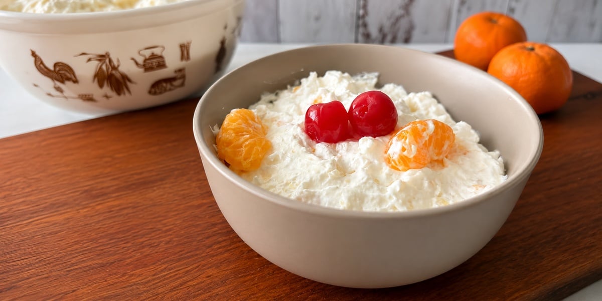Easy fruit fluff recipe made with mandarin oranges, pineapple, Cool Whip, and cheesecake pudding.