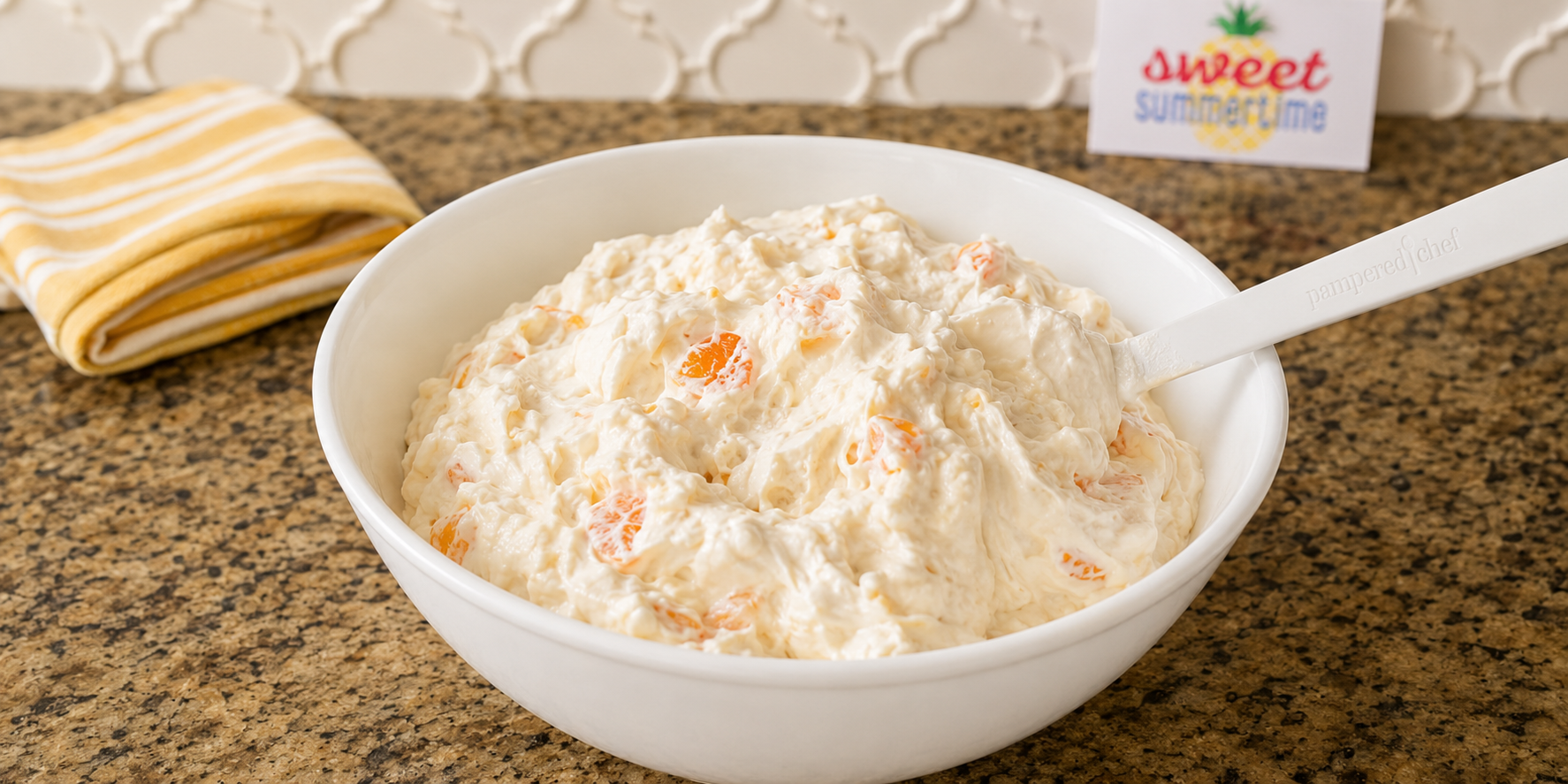 All the ingredients mixed together in a white bowl to make fruit fluff recipe.