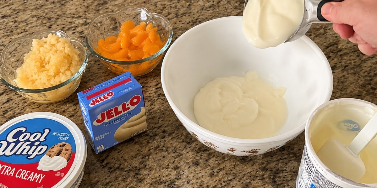 Mixing vanilla yogurt and cheesecake pudding mix for fruit fluff recipe.