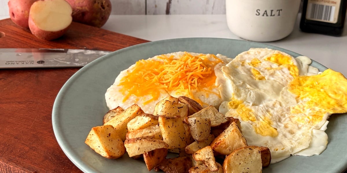 Low angle view of crispy seasoned air fryer red potatoes served on a breakfast plate