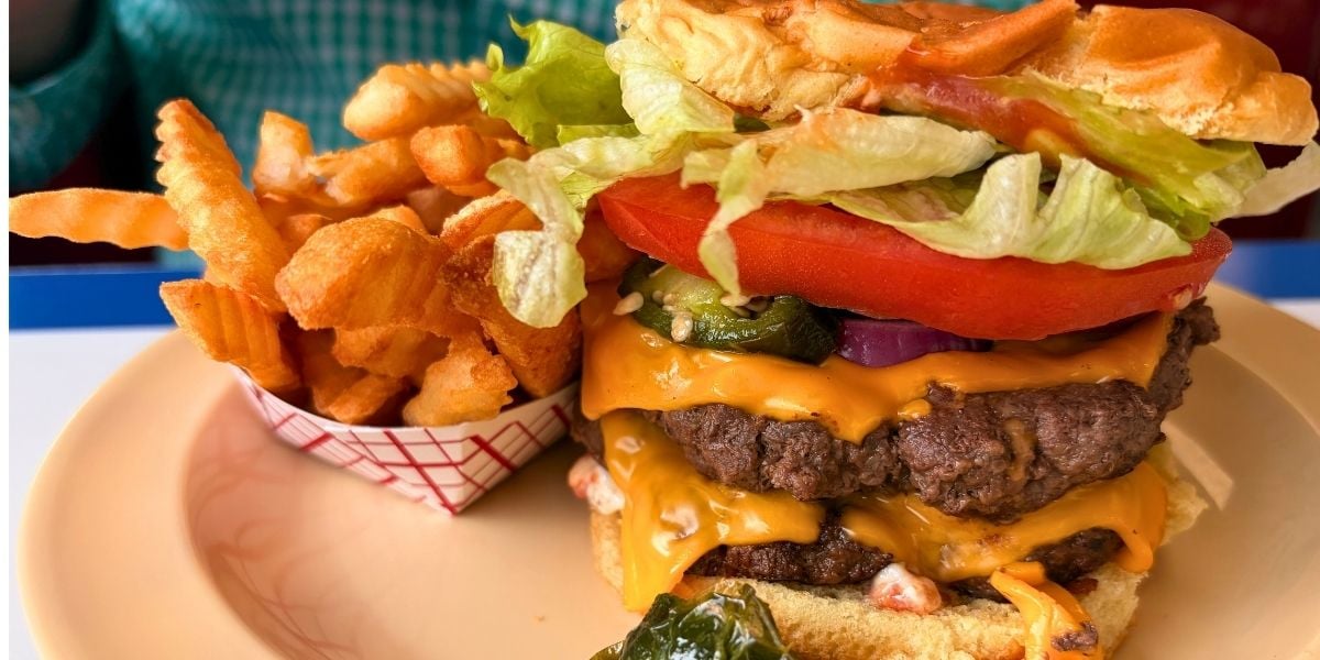 loaded double cheeseburger with melted cheddar, jalapeños, lettuce, and tomato served with crinkle-cut fries at Strawberry Hill USA Cafe in Chesnee, South Carolina.