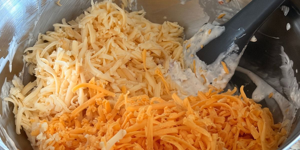 Freshly grated Gouda and cheddar added to the pimento cheese mixture.